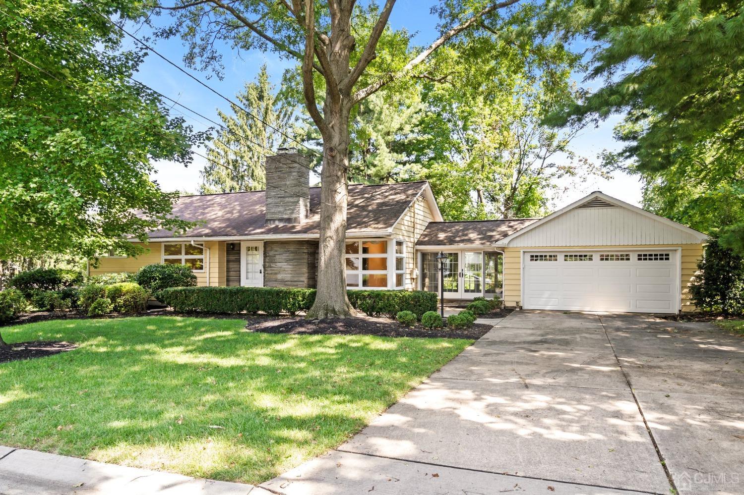 a front view of a house with a garden