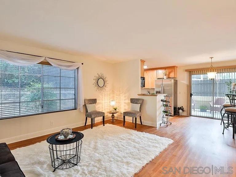 a living room with furniture a rug and a large window