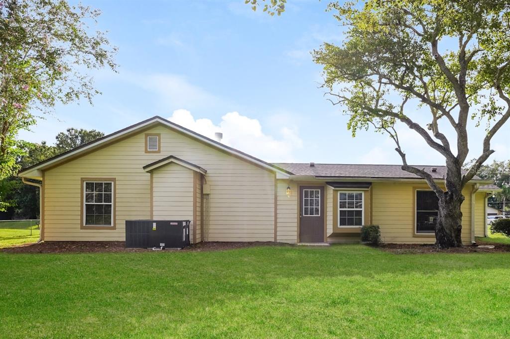 a view of a house with a backyard