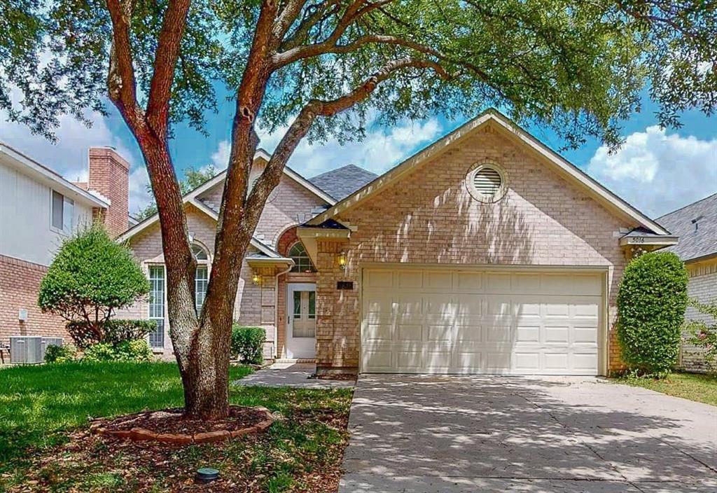 a view of a house with a tree in the yard