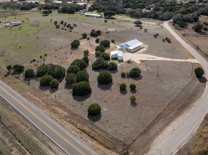 an aerial view of a house with a yard