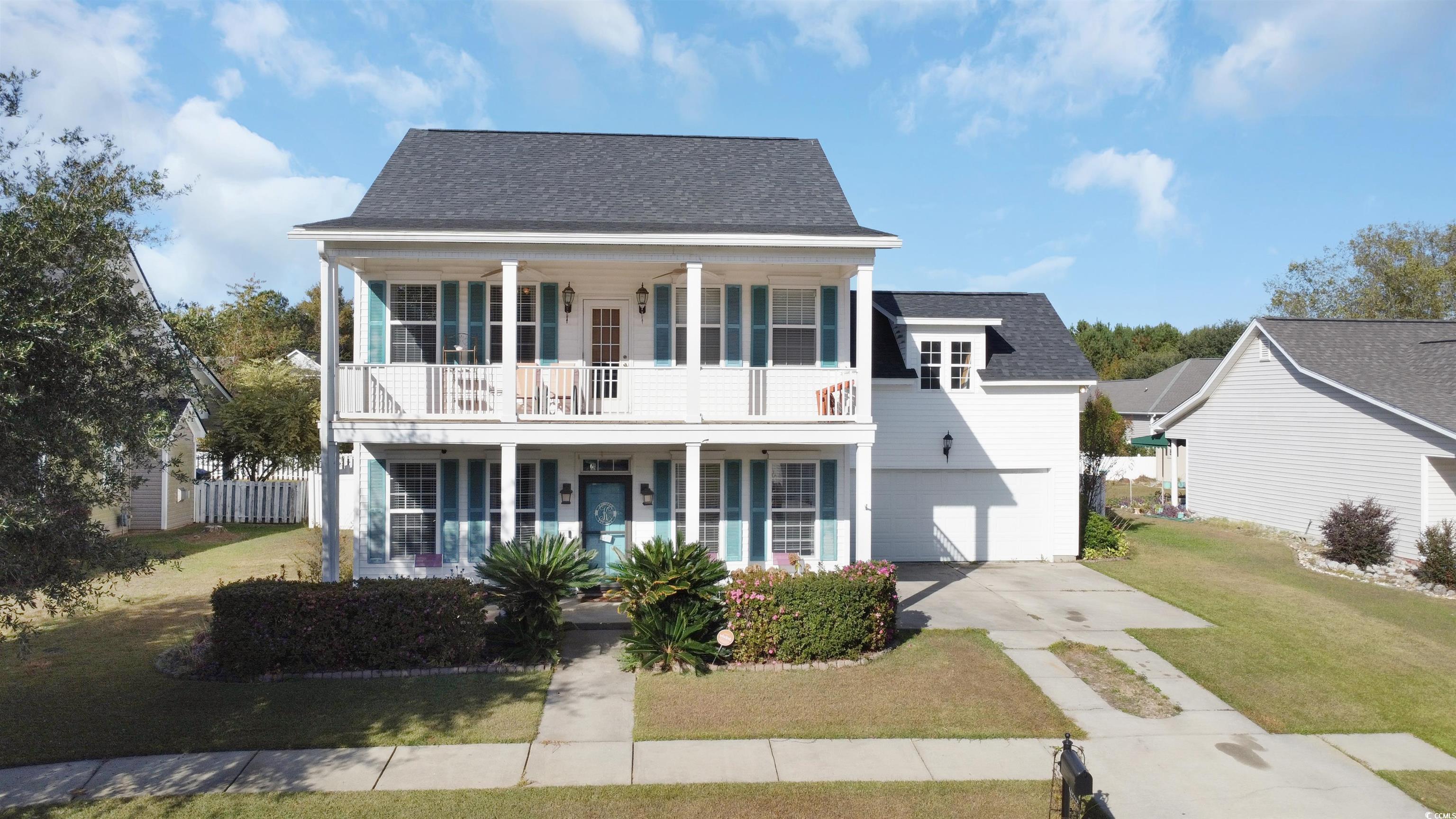 View of front facade with a garage, covered porch,