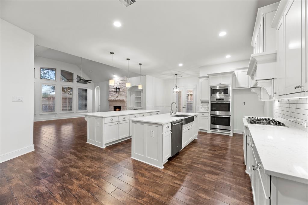 Welcome to 10519 Grace Hollow! Gorgeous double-island kitchen flows seamlessly into the spacious family room.