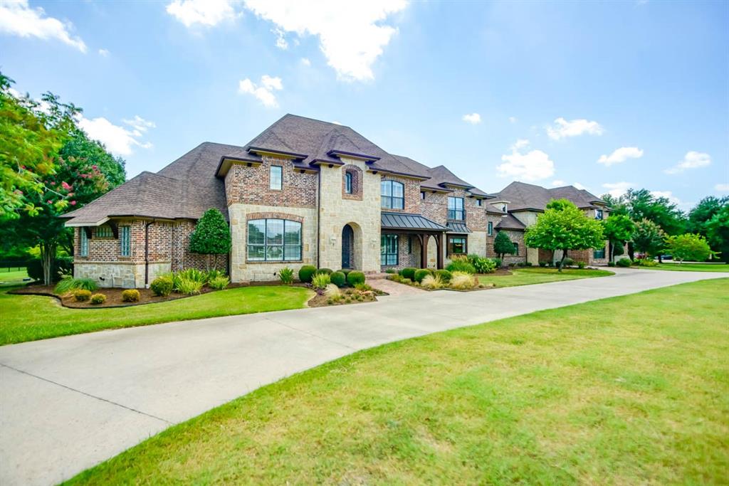 a front view of a house with yard and green space