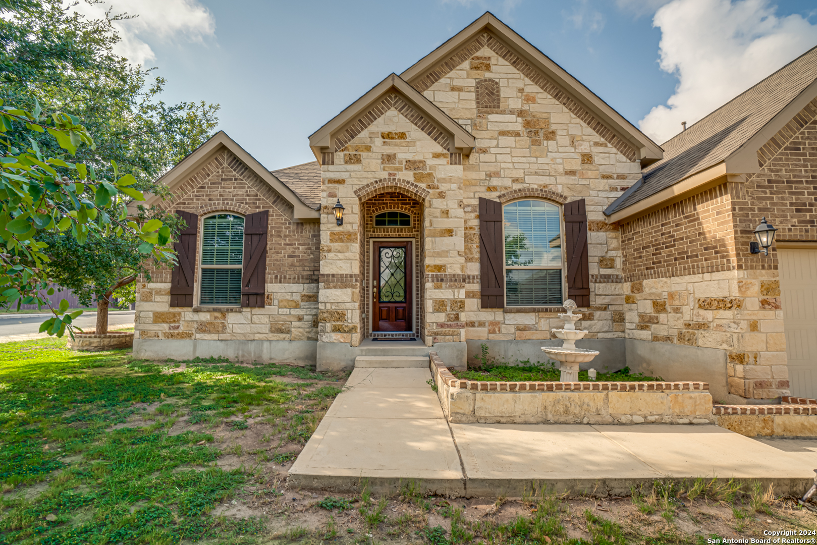 a front view of a house with garden