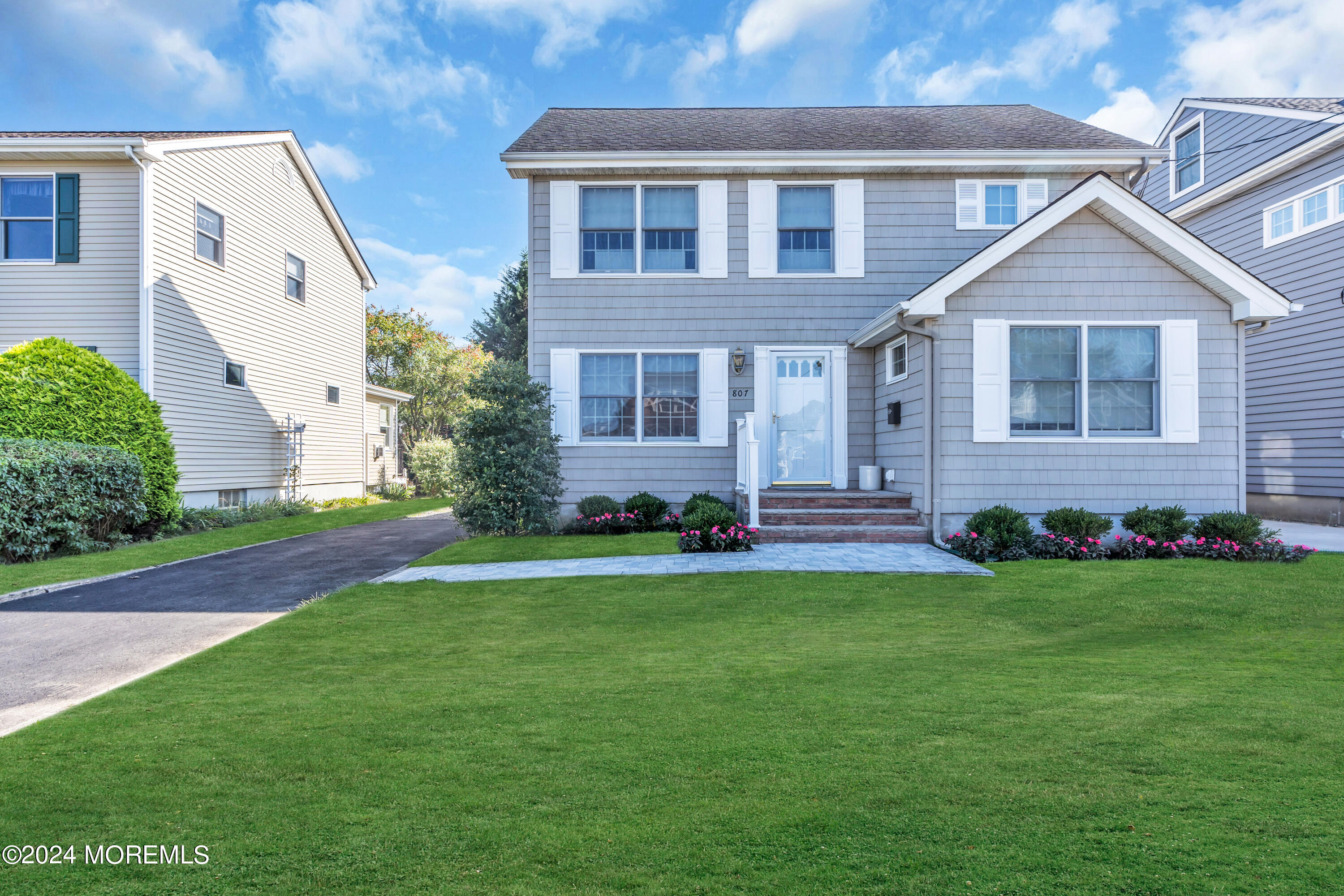 a front view of a house with a garden