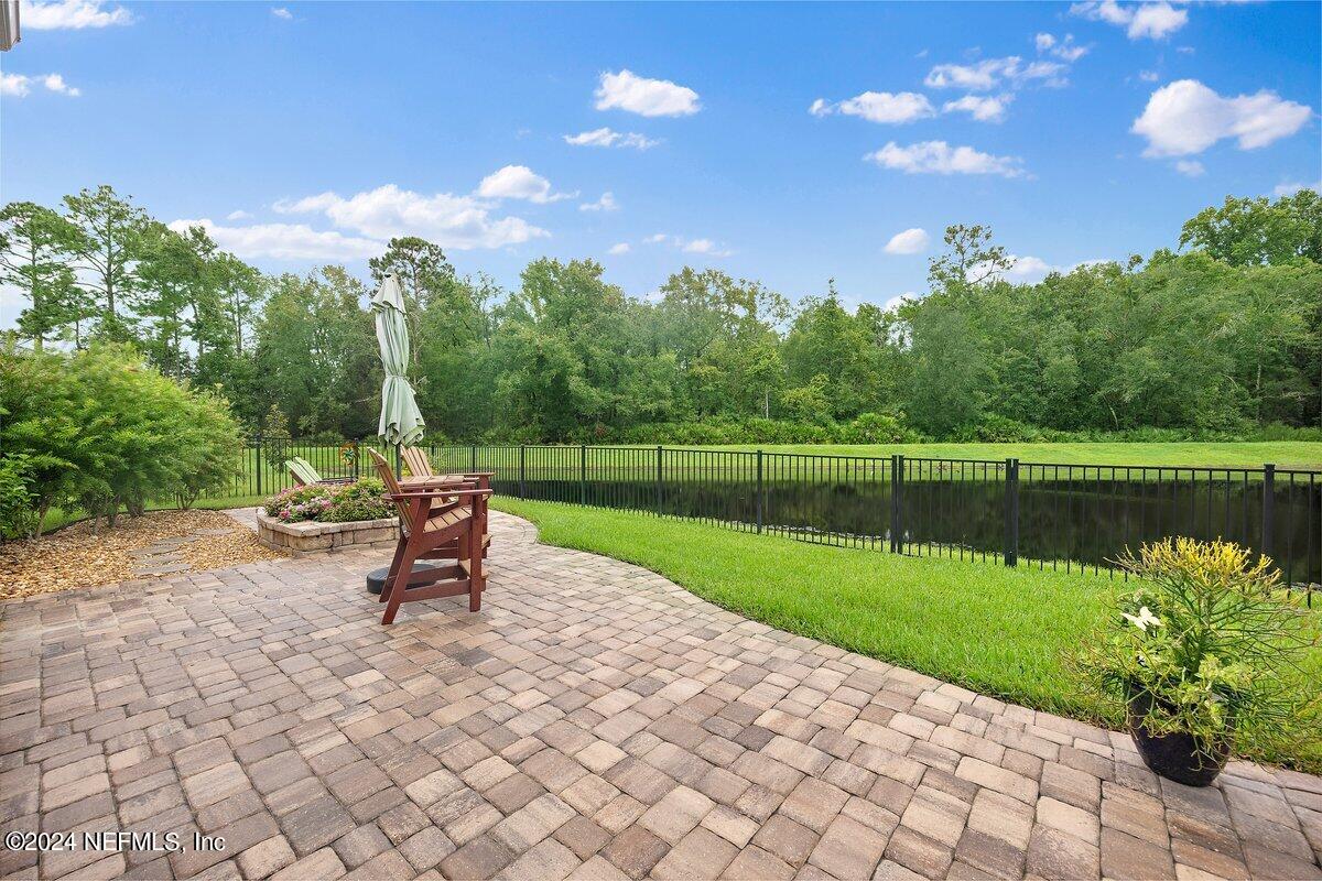 a view of a lake with a yard and a bench