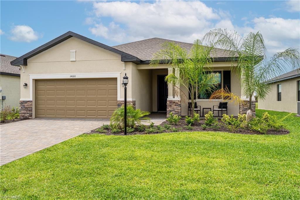 a front view of a house with a yard and garage