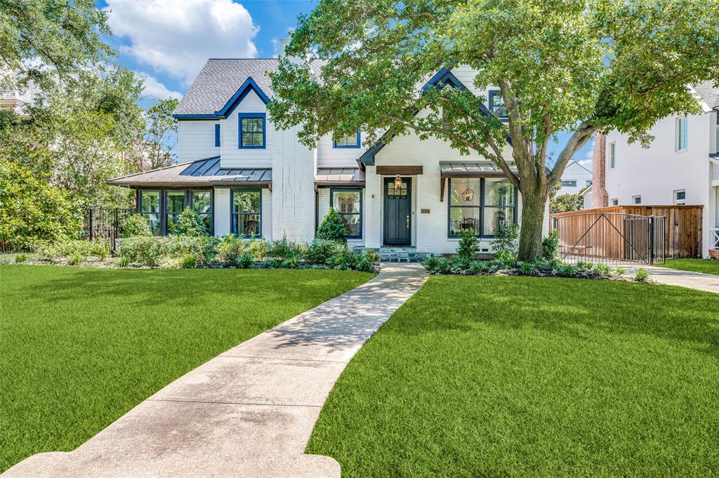 a front view of a house with a garden and yard