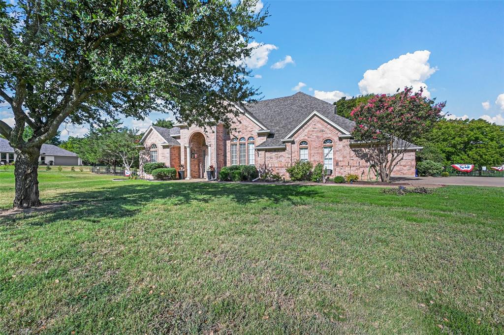 a front view of house with yard and green space