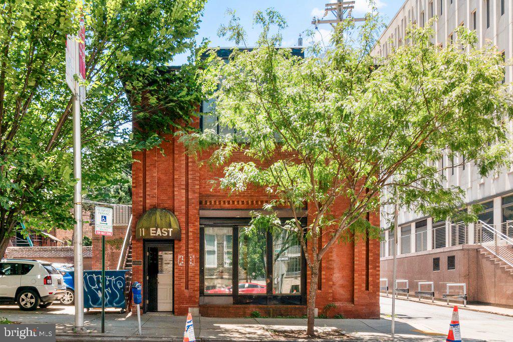 front view of a building with a tree