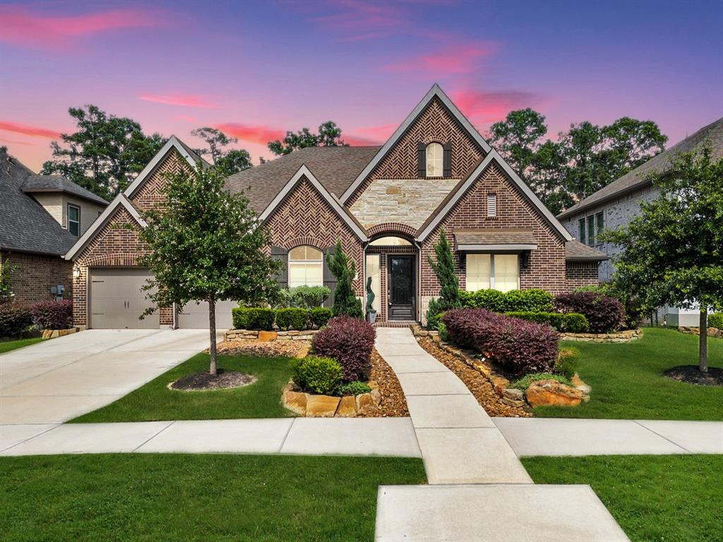 a front view of a house with a garden and plants