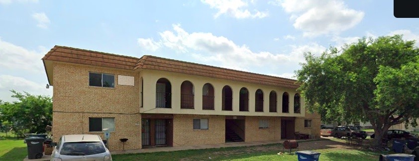 a view of house with yard and sitting area