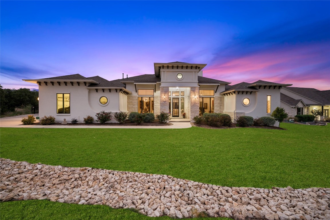 a front view of a house with a garden