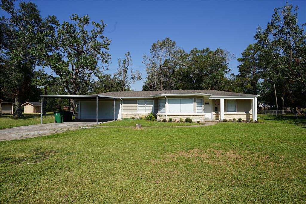 a front view of house with yard and outdoor seating