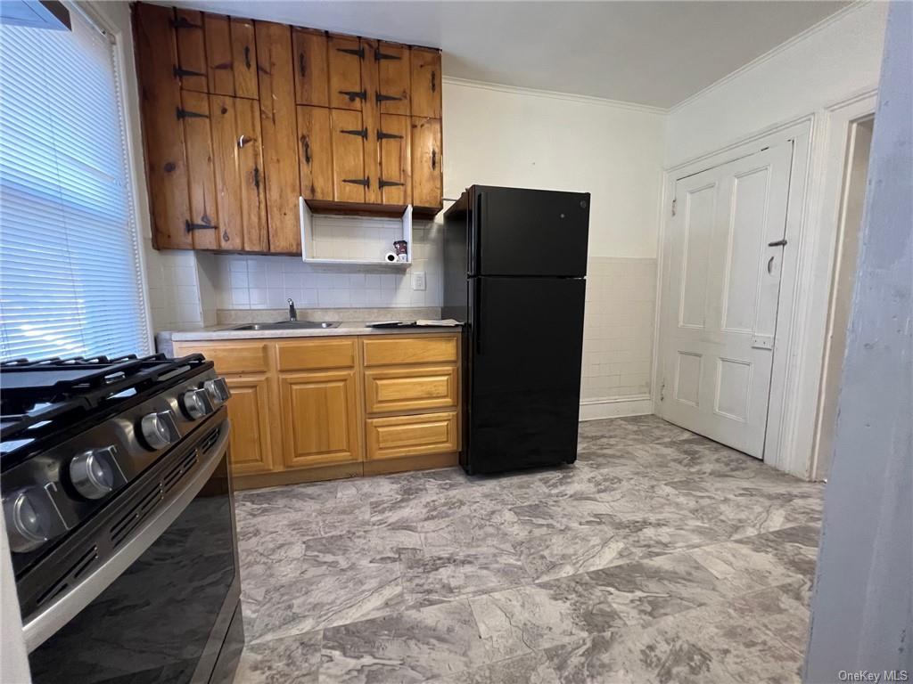 a kitchen with a stove and a refrigerator