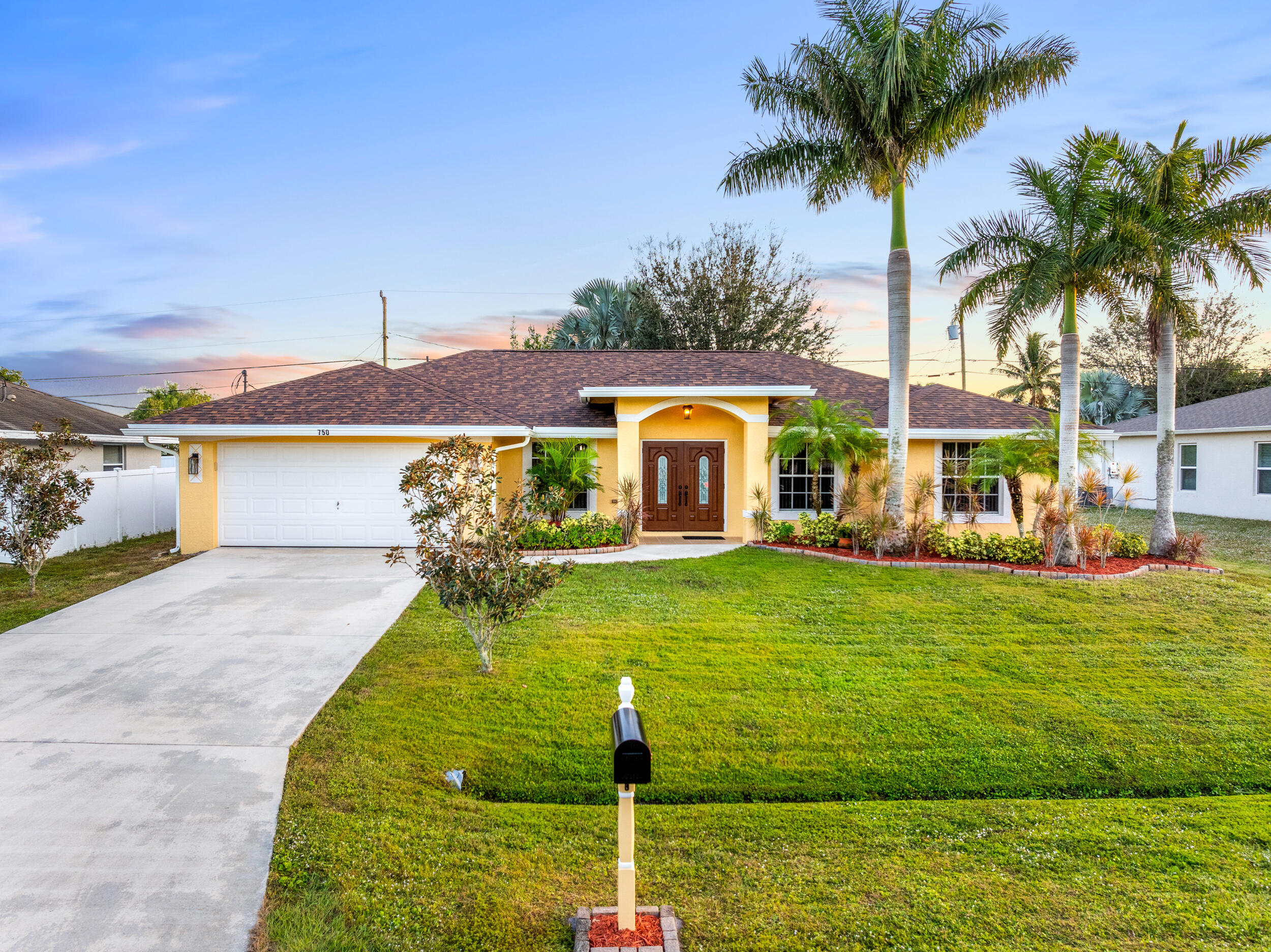 a front view of house with yard and swimming pool