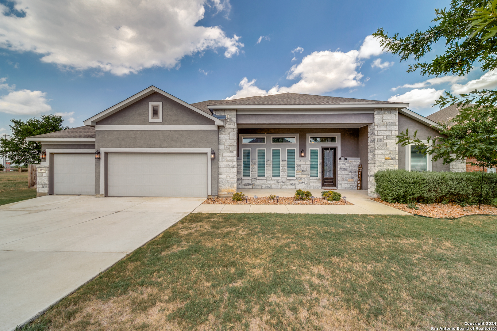 a front view of a house with a yard and garage