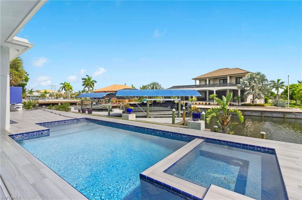 a view of swimming pool with outdoor seating