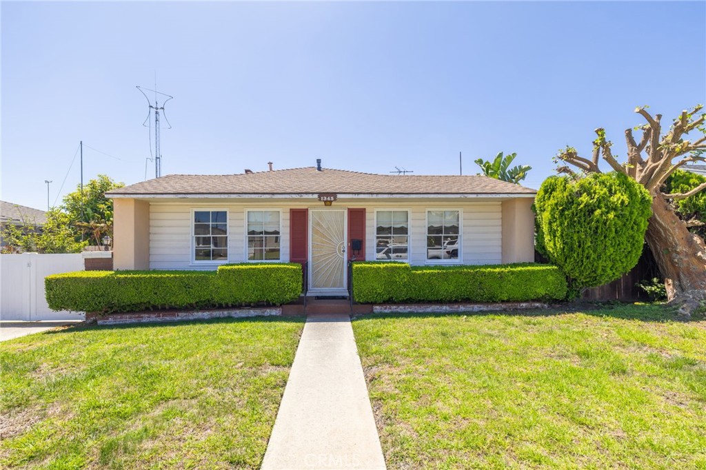 a view of a house with a yard and plants