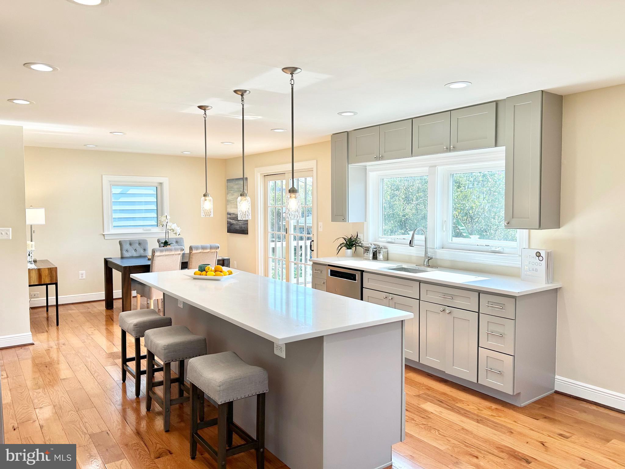 a large kitchen with kitchen island a large window