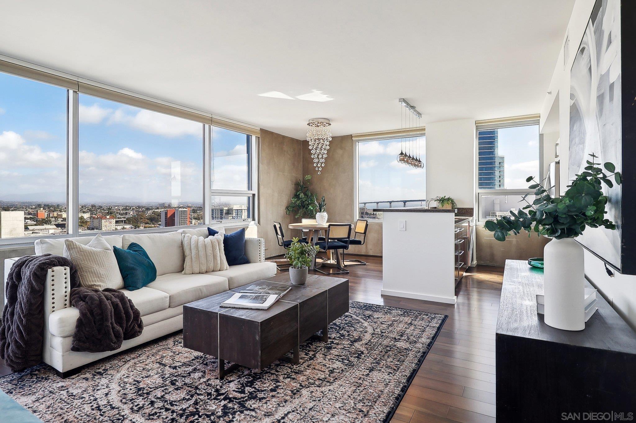 a living room with furniture wooden floor and a table