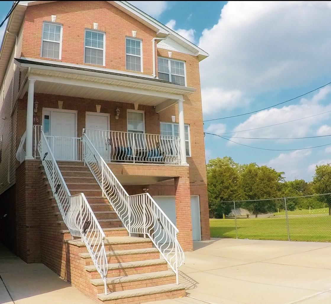 a view of a brick house with a yard