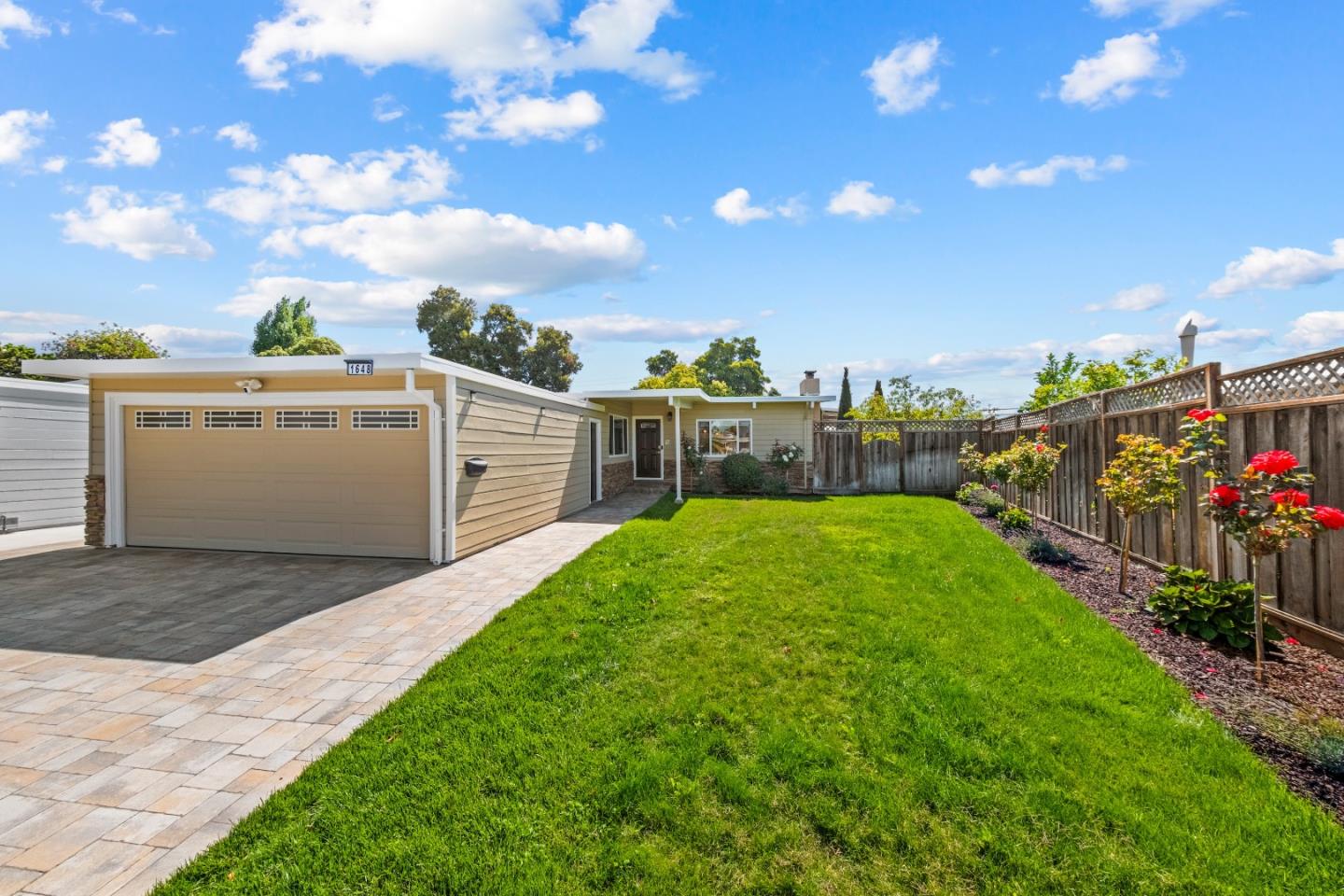 a view of a backyard with sitting area