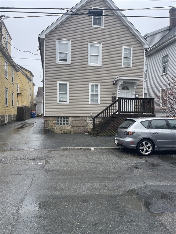 a view of a car parked front of a house