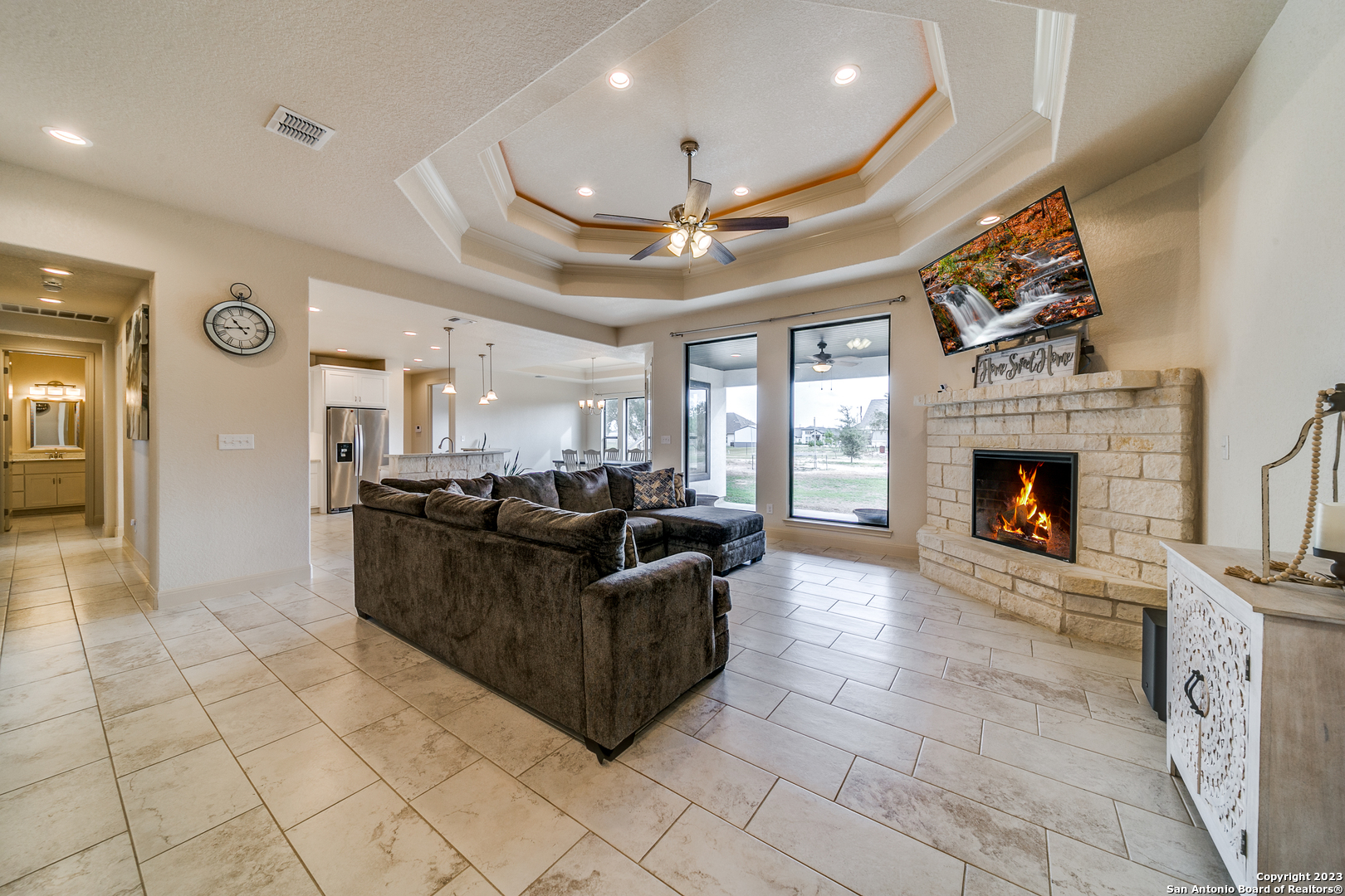 a living room with furniture a fireplace and a flat screen tv