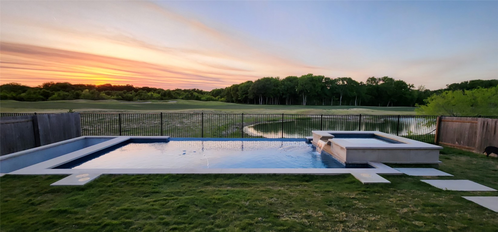 a view of a lake with couches in the patio