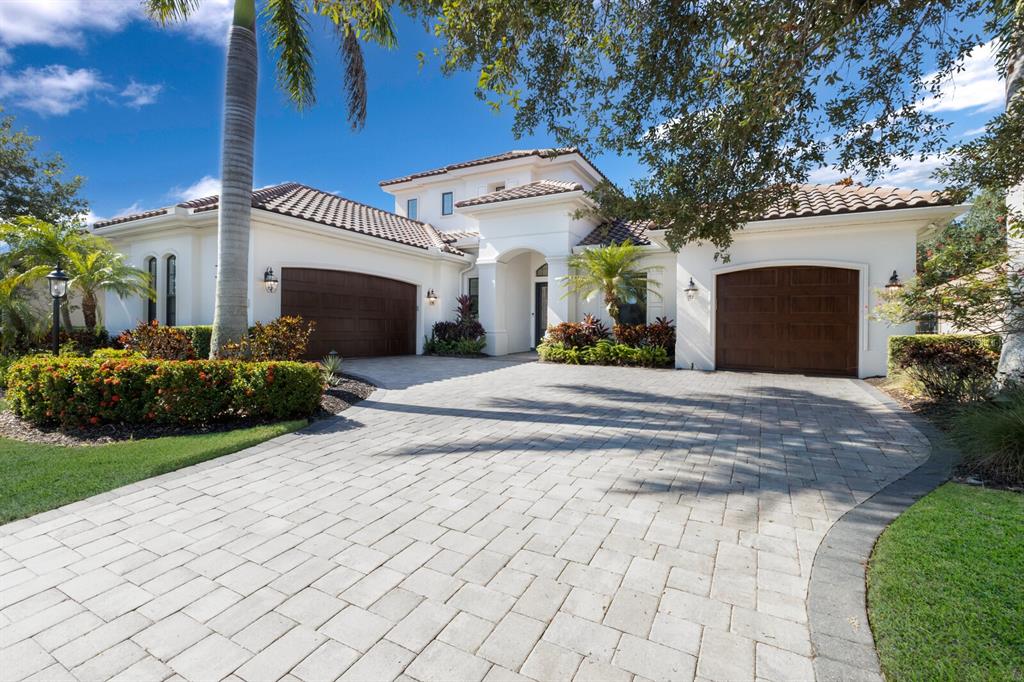 a front view of a house with a yard and a garage