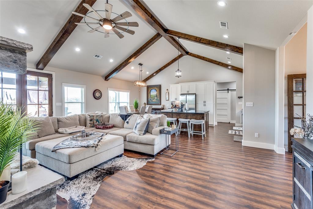 a living room with furniture or chandelier and a wooden floor