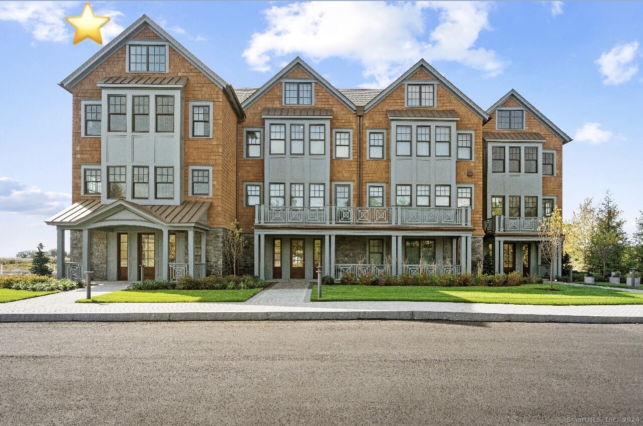 a front view of building with yard and green space