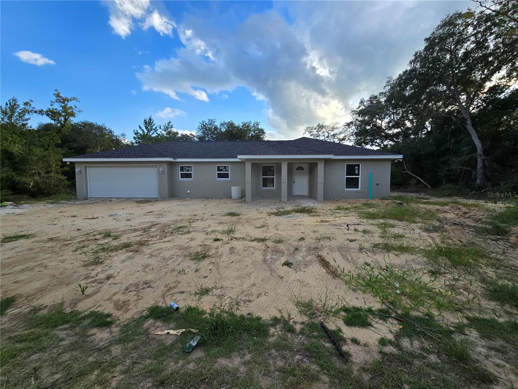 a view of house with backyard and trees