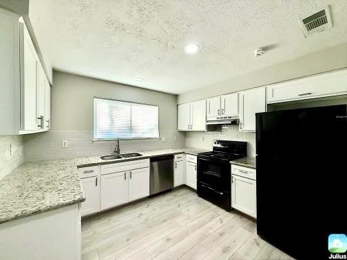 a kitchen with stainless steel appliances granite countertop a stove sink and cabinets