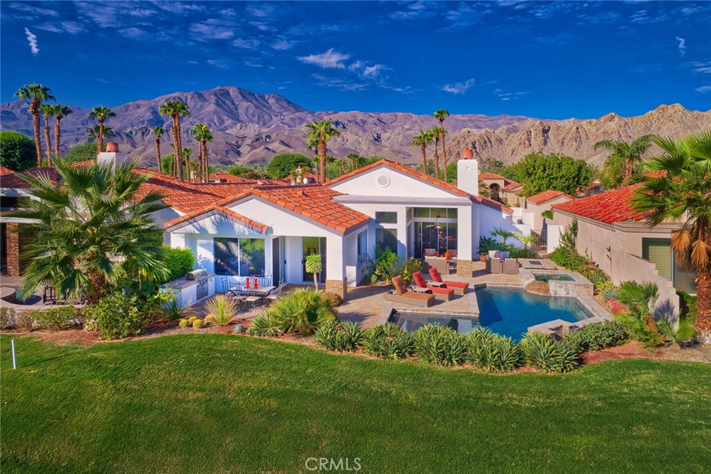 a view of a house with swimming pool garden and patio