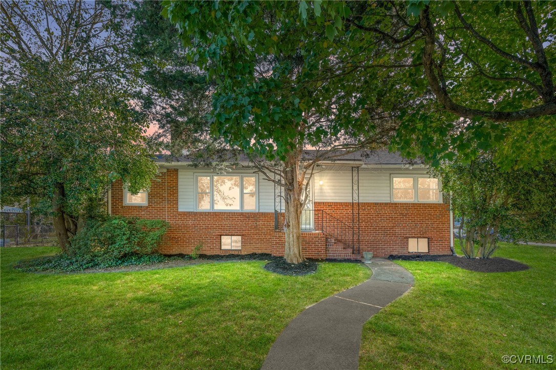 a front view of a house with a garden