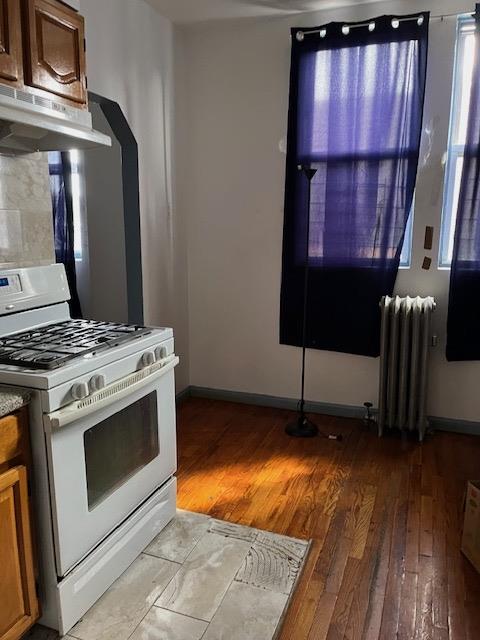 a stove top oven sitting inside of a kitchen