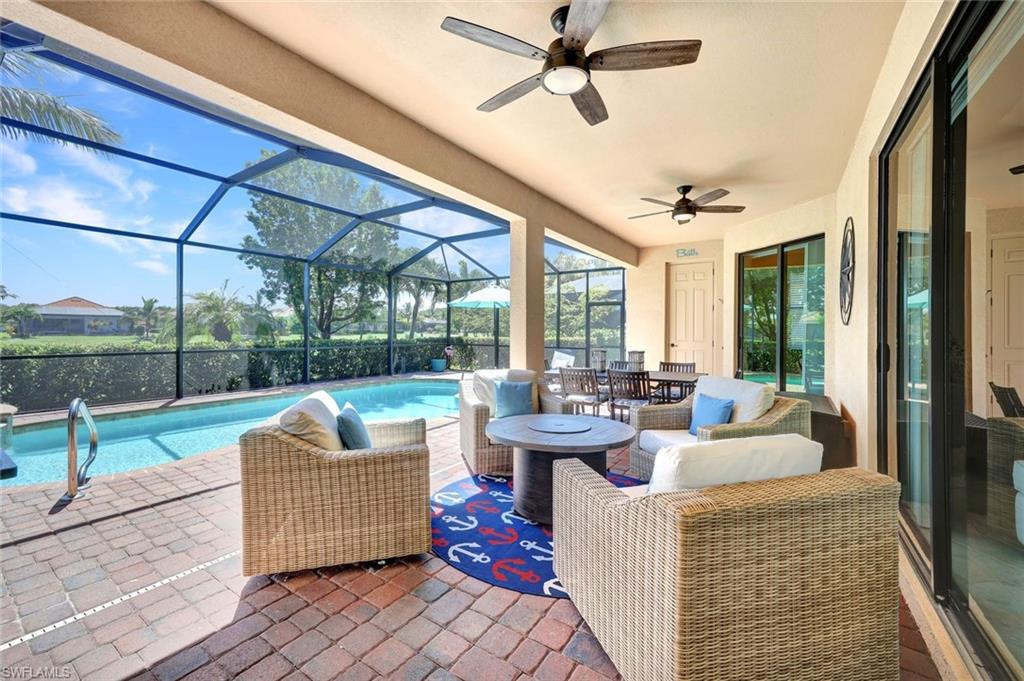 a living room with patio furniture and a garden