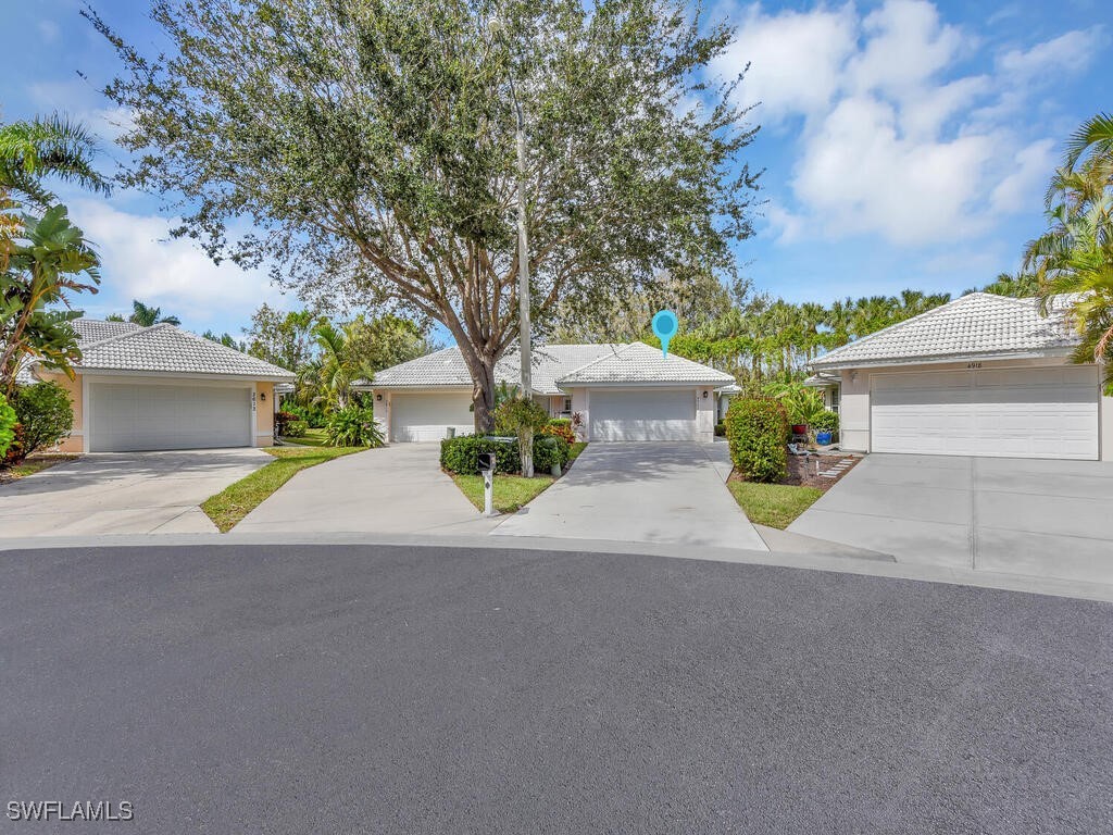 a view of a house with a yard and a garage