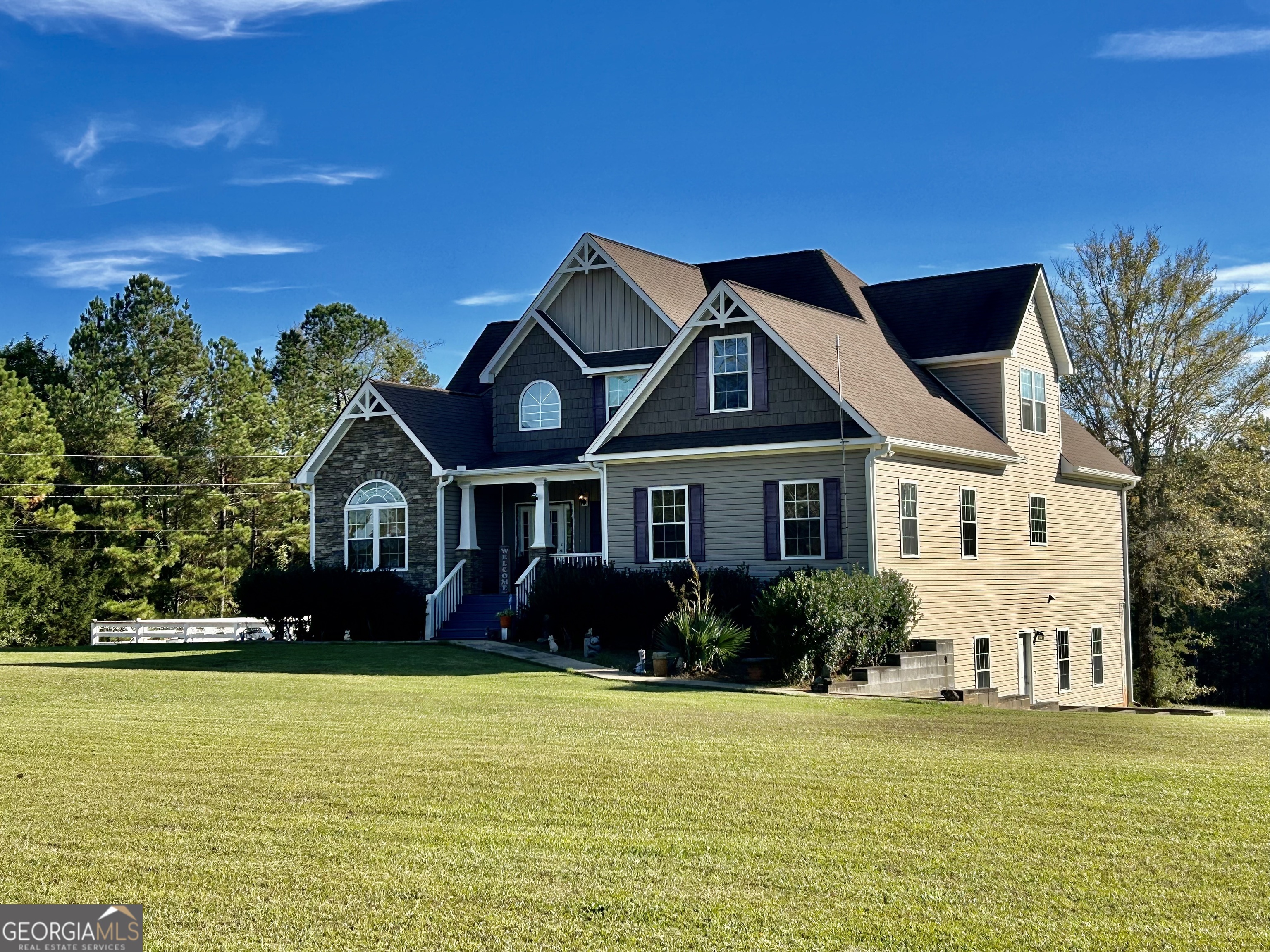 a front view of a house with a garden