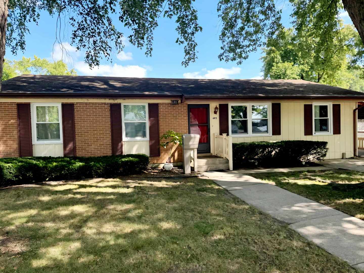 a front view of a house with yard and seating space