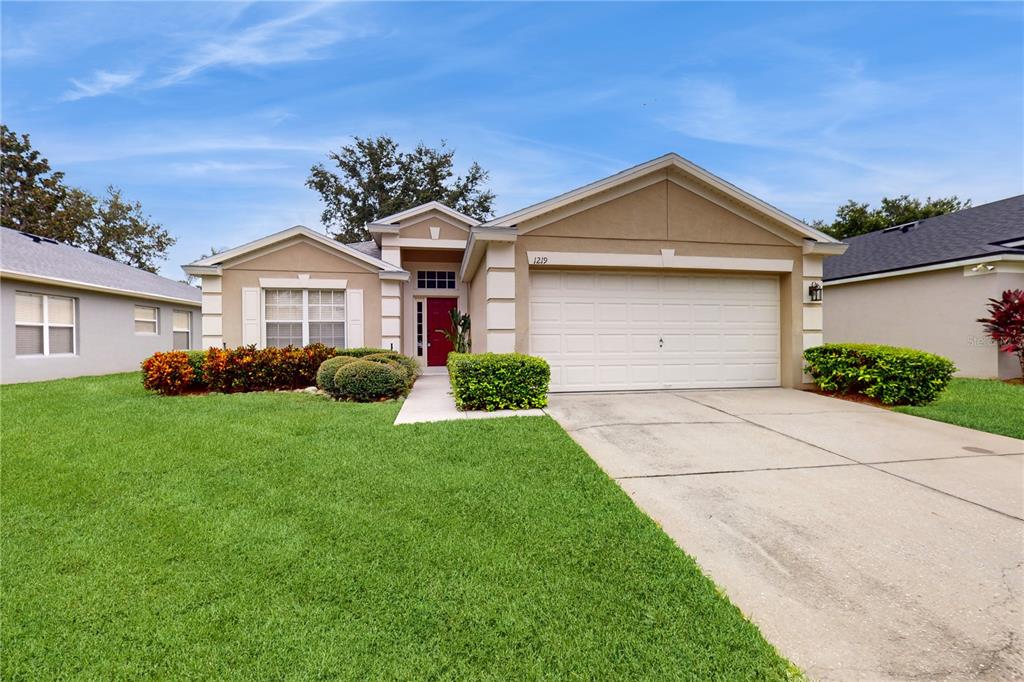 a front view of a house with a yard and garage