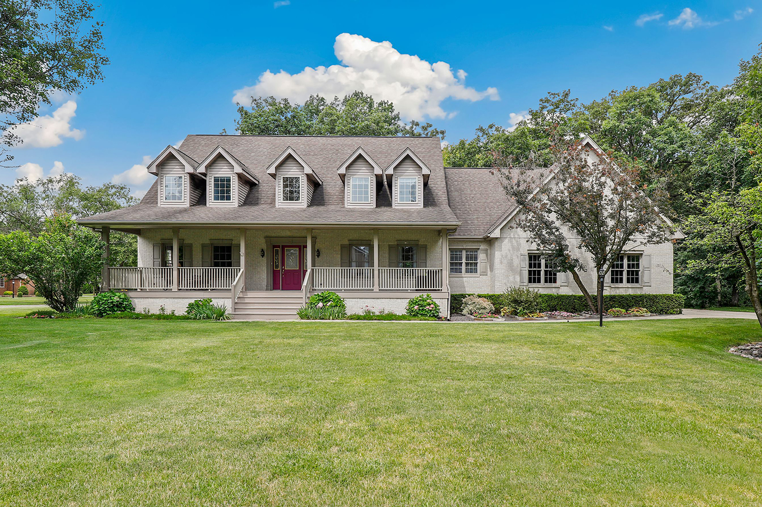 a view of a house with a garden and porch