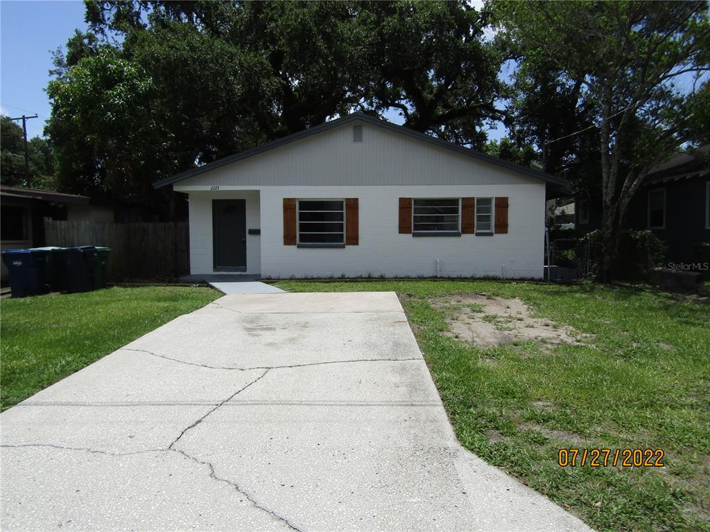 a house that has a tree in front of a yard