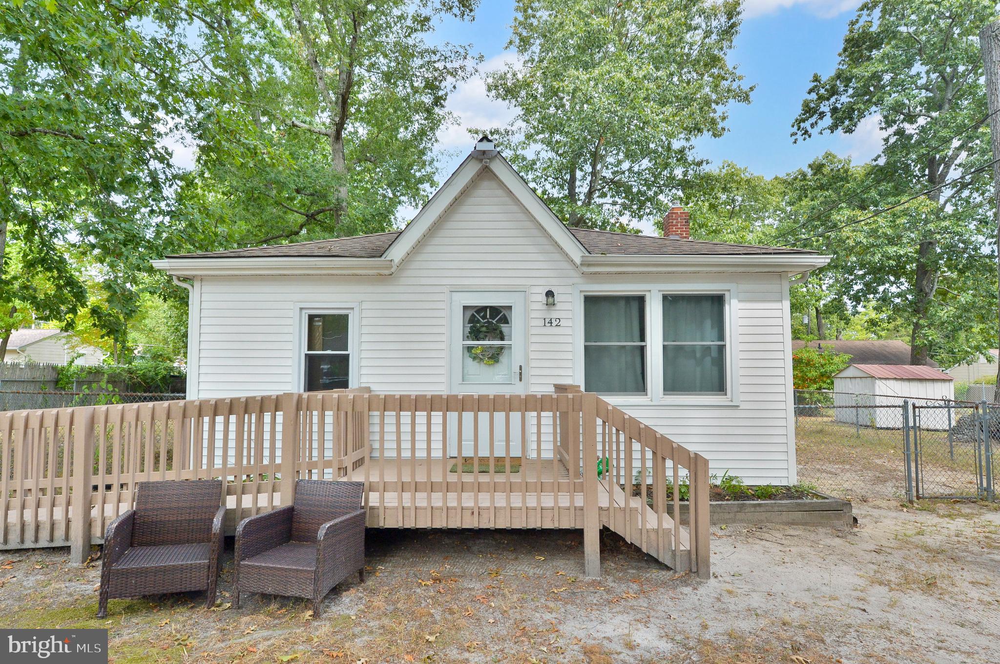 a view of a deck with furniture and a yard