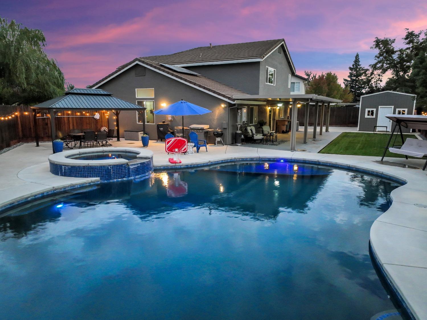 a view of a house with swimming pool yard and sitting area