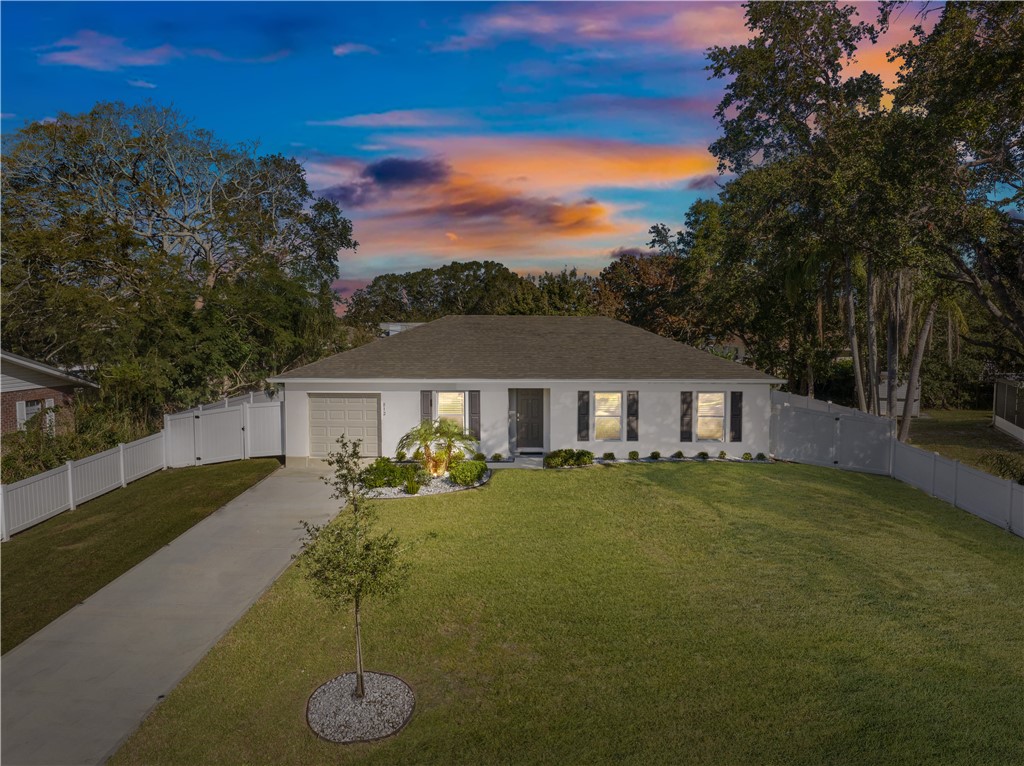 a view of a house with a backyard