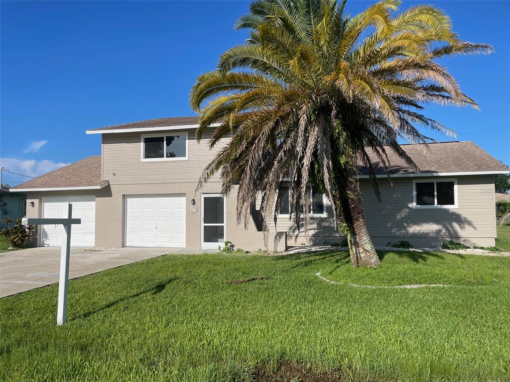 a house that has a tree in front of the house